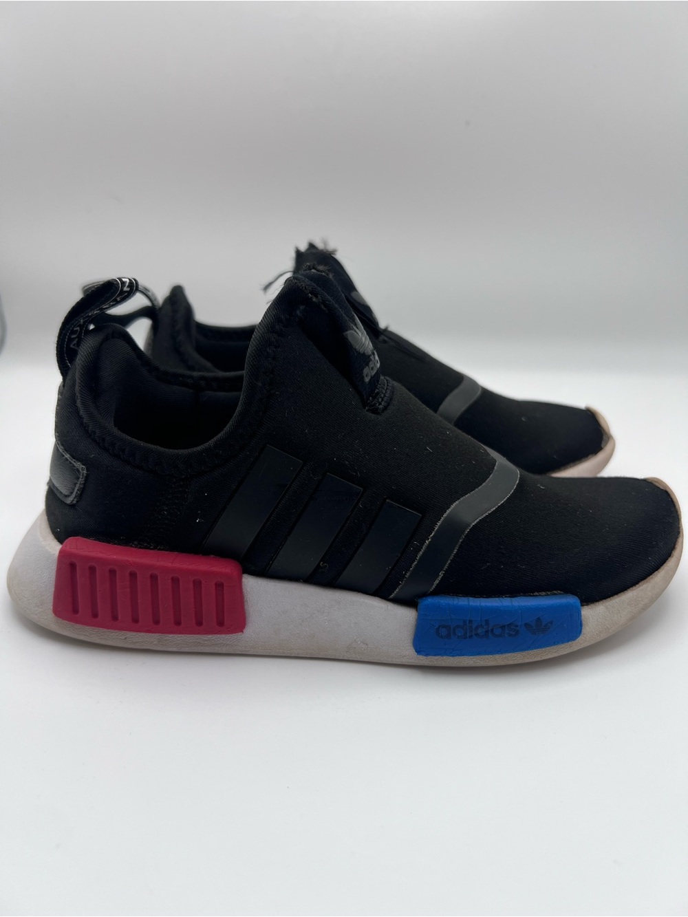 adidas NMB Kids Black Slip-On Sneakers with Blue & Red Midsole Accent - Picture 2 of 9